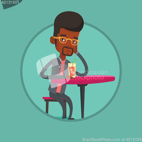 Image of Man drinking cocktail at the bar.