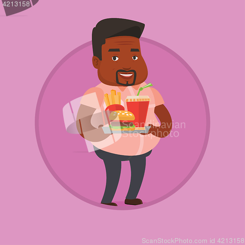 Image of Man holding tray full of fast food.