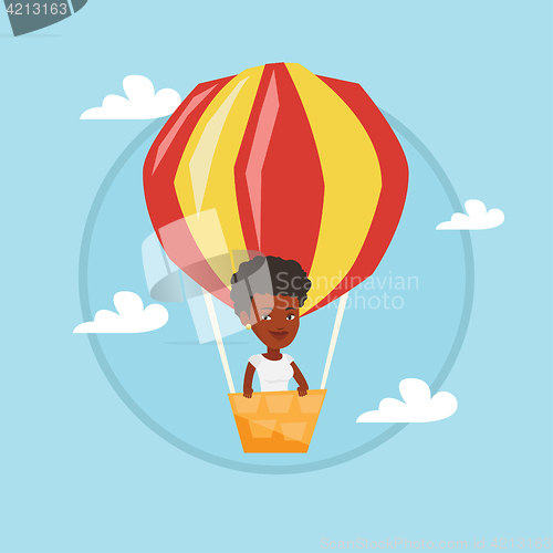 Image of Young woman flying in hot air balloon.