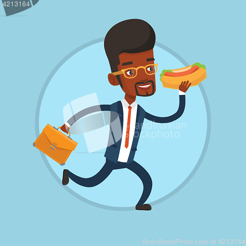 Image of Businessman eating hot dog on the run.