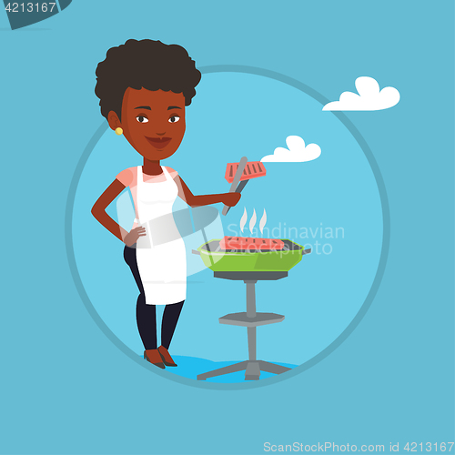 Image of Woman cooking steak on barbecue grill.