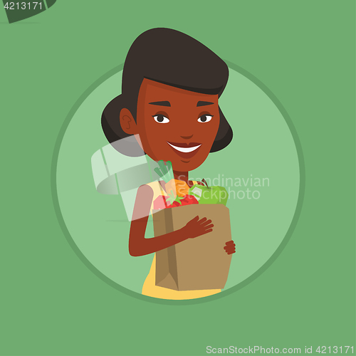 Image of Happy woman holding grocery shopping bag.