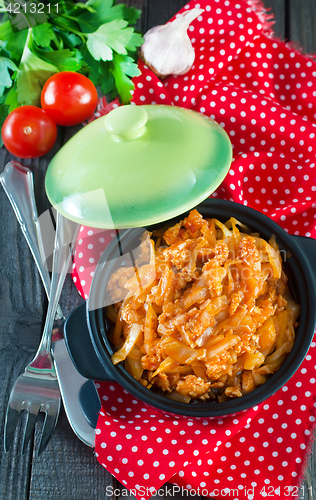 Image of fried cabbage in bowl and on a table