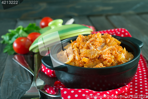 Image of fried cabbage in bowl and on a table