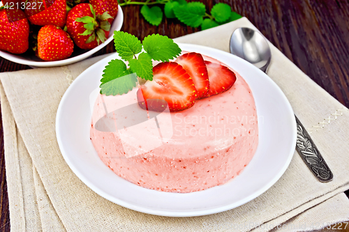 Image of Panna cotta strawberry with mint on dark board