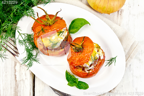 Image of Tomatoes stuffed with meat and rice in plate on board top
