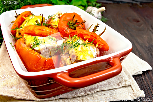 Image of Tomatoes stuffed with rice and meat in brazier on towel