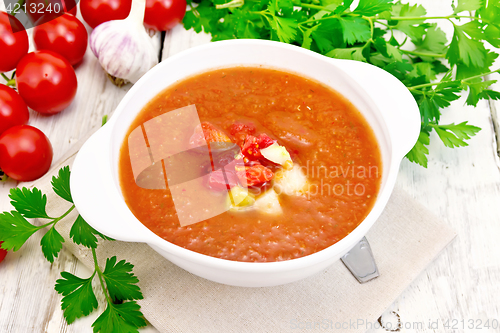 Image of Soup tomato in white bowl on light board