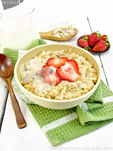 Image of Oatmeal with strawberries on green napkin