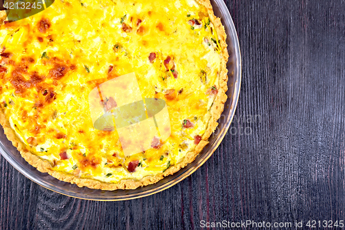 Image of Quiche with pumpkin and bacon in pan on board top