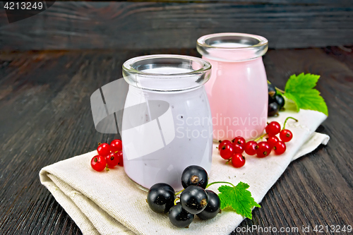 Image of Milk cocktail with black and red currant on napkin