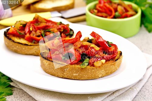 Image of Bruschetta with vegetables in plate on granite table