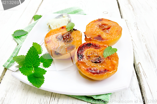 Image of Quince baked with ice cream in plate on green napkin