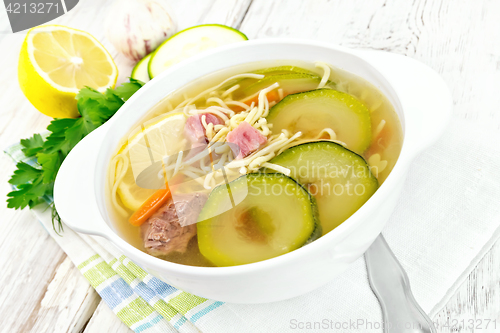 Image of Soup with zucchini and noodles on board