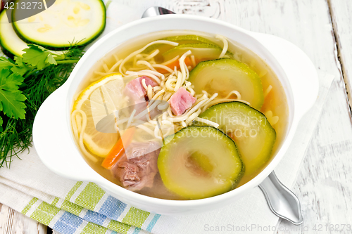 Image of Soup with zucchini and noodles on napkin