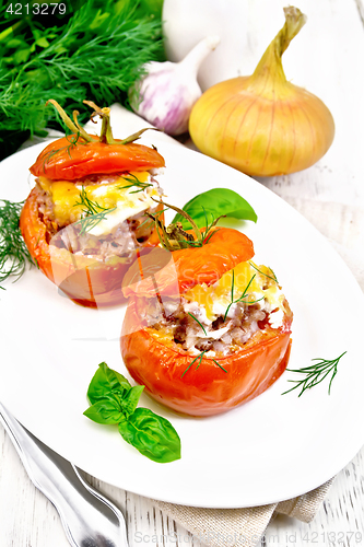 Image of Tomatoes stuffed with meat and rice in plate on board