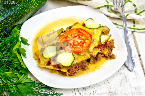 Image of Casserole from minced meat and zucchini in plate on table