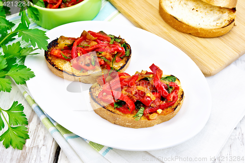 Image of Bruschetta with tomatoes and peppers in plate on light board