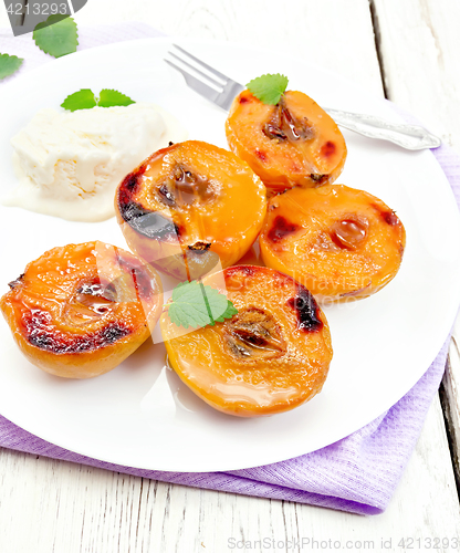 Image of Quince baked with ice-cream in plate on towel