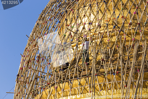 Image of Worker repareing golden temple