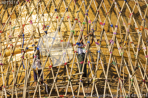 Image of Worker repareing golden temple