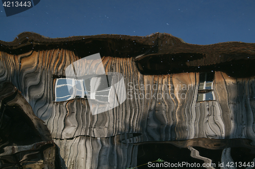 Image of Reflection of a wooden house at the ecomusee in Alsace