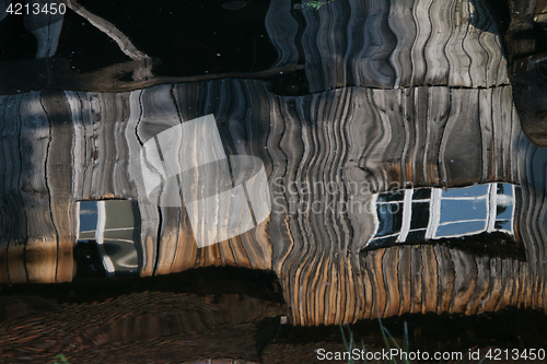 Image of Reflection of a wooden house at the ecomusee in Alsace