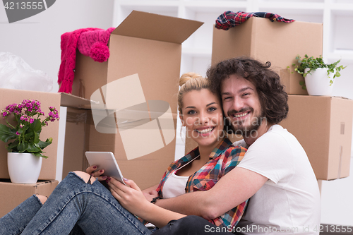 Image of young couple moving  in new house