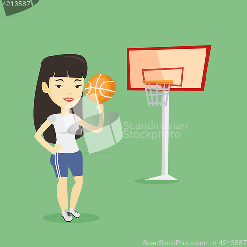 Image of Young basketball player spinning ball.