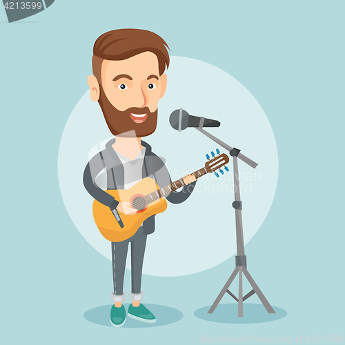 Image of Man singing in microphone and playing guitar.