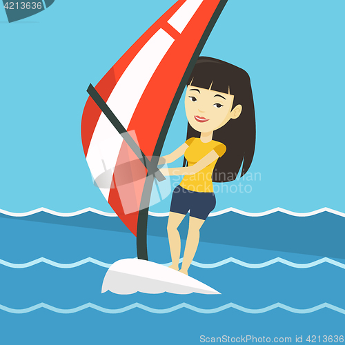 Image of Young woman windsurfing in the sea.