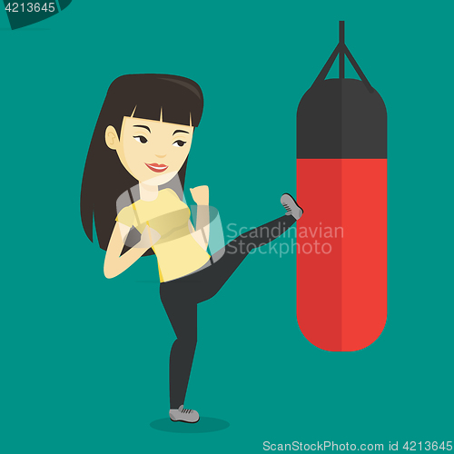 Image of Woman exercising with punching bag.