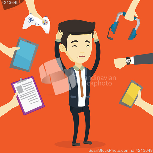 Image of Young man surrounded with his gadgets.
