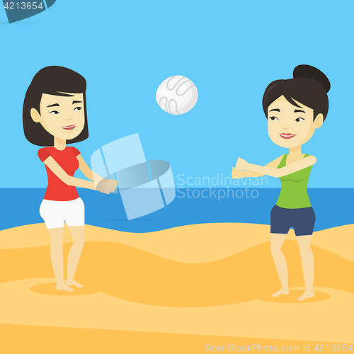 Image of Two women playing beach volleyball.