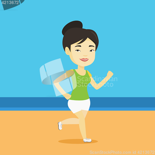 Image of Young sporty woman jogging on the beach.