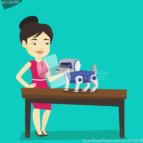 Image of Happy young woman playing with robotic dog.