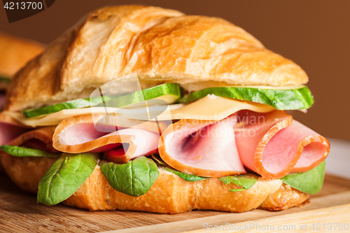 Image of Croissants sandwiches on the wooden cutting board