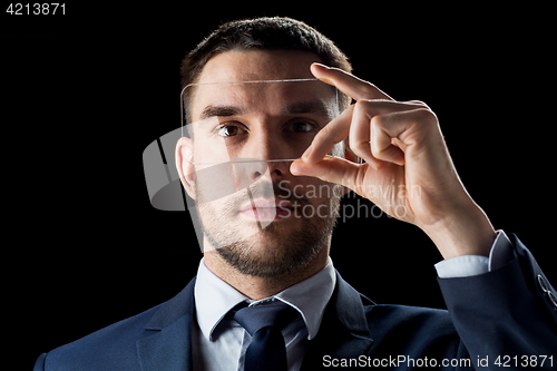 Image of businessman with transparent smartphone