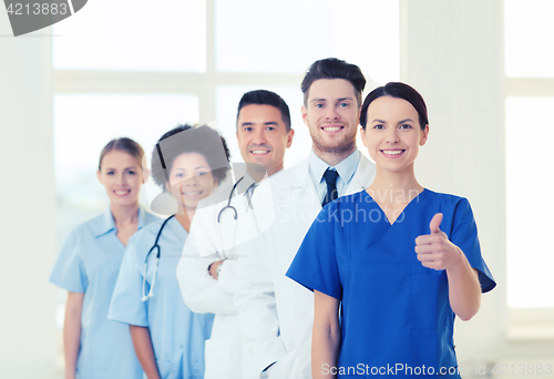 Image of happy doctors showing thumbs up at hospital