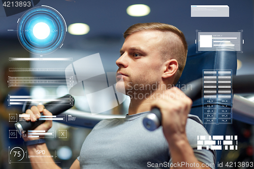 Image of man exercising and flexing muscles on gym machine