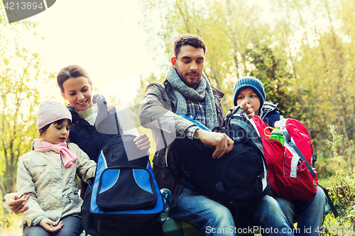 Image of happy family with backpacks at camp