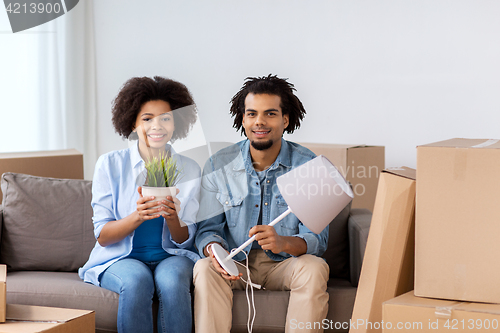 Image of happy couple with stuff moving to new home