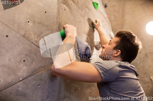 Image of young man exercising at indoor climbing gym