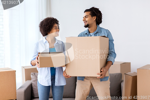 Image of happy couple with boxes moving to new home