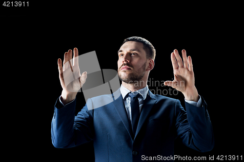 Image of businessman in suit over black