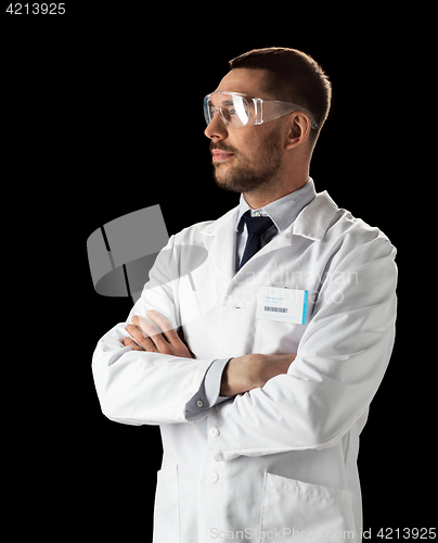Image of doctor or scientist in lab coat and safety glasses