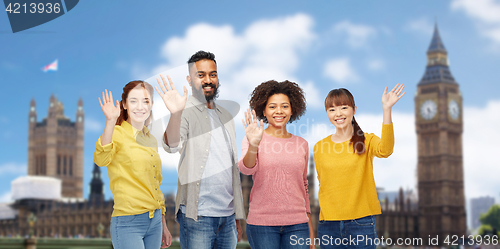 Image of international group of happy people waving hands