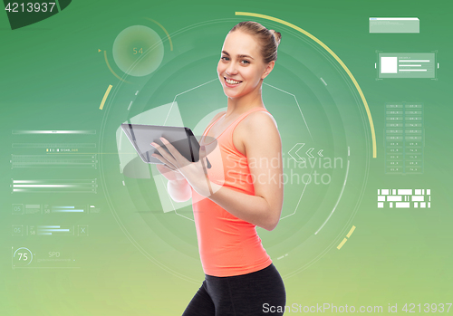 Image of happy smiling sportive young woman with tablet pc