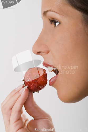 Image of Biting into a strawberry