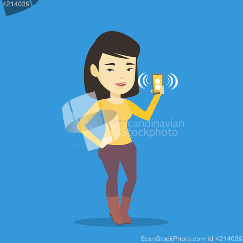 Image of Woman holding ringing mobile phone.